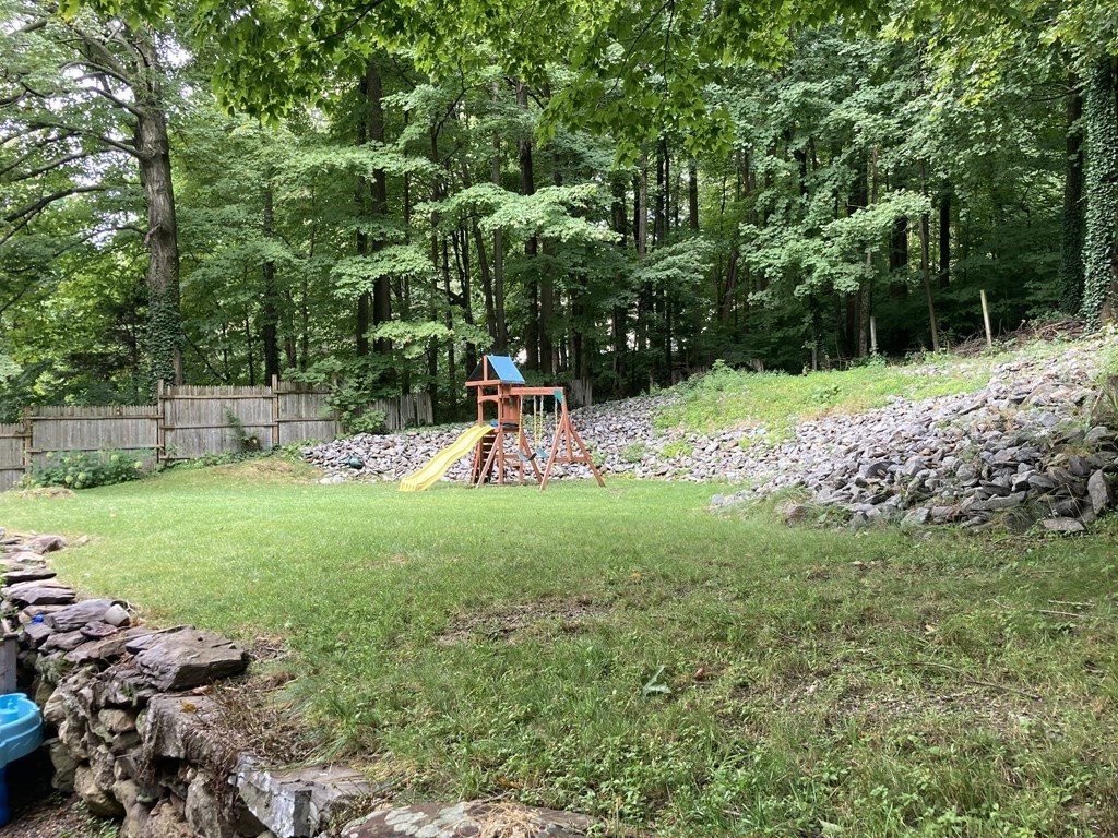 24 Baxter Street Worcester, MA 01602 - Photo 33 of 36 a view of backyard with table and chairs and large trees