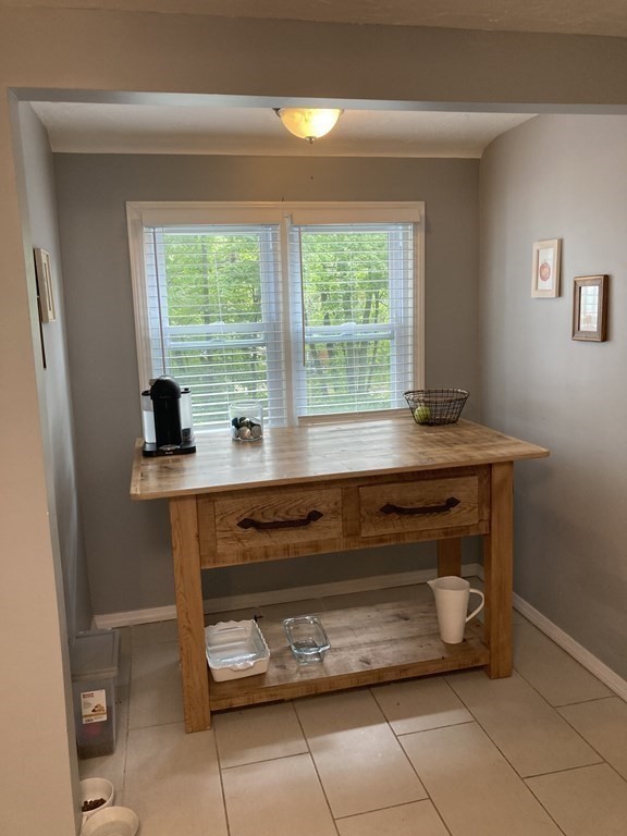 24 Baxter Street Worcester, MA 01602 - Photo 10 of 36 a room with a table and a window