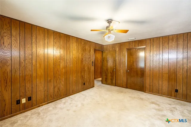 a view of an empty room with a fan
