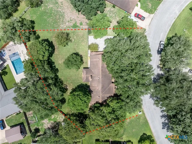 an aerial view of a house with a yard