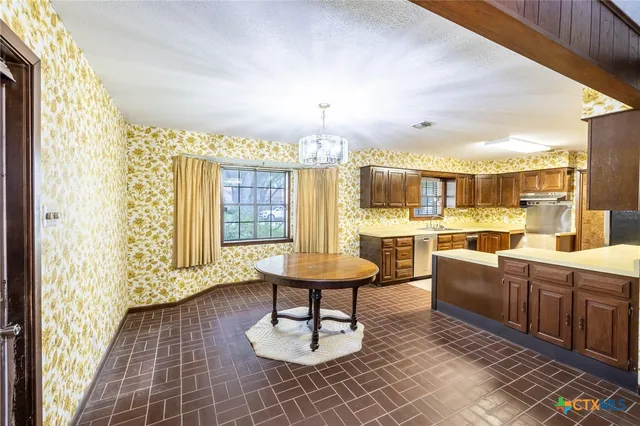 a room with lots of wooden furniture and a table