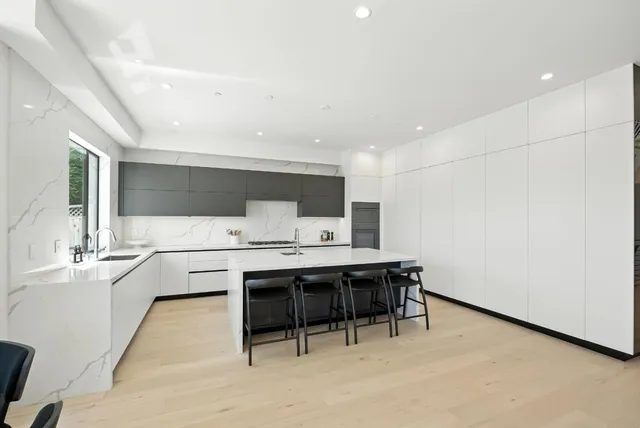 a spacious bedroom with a large bed and a large window