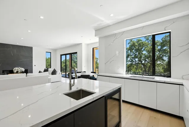 a bathroom with a double vanity sink mirror and shower
