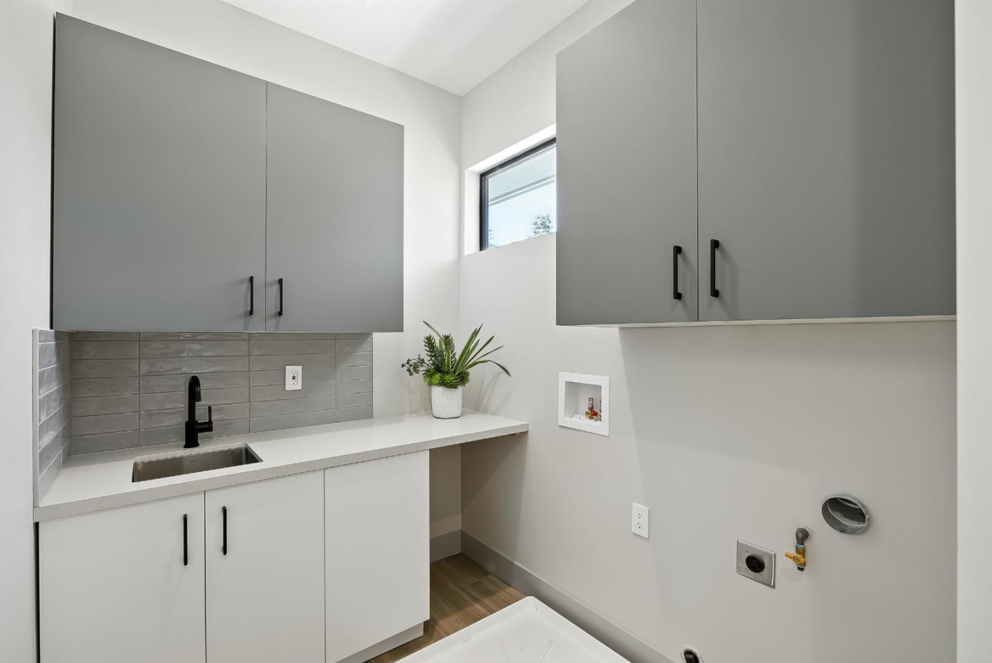 1127 Hillslope Place Los Altos, CA 94024 - Photo 41 of 70 a white kitchen with sink a window and potted plant