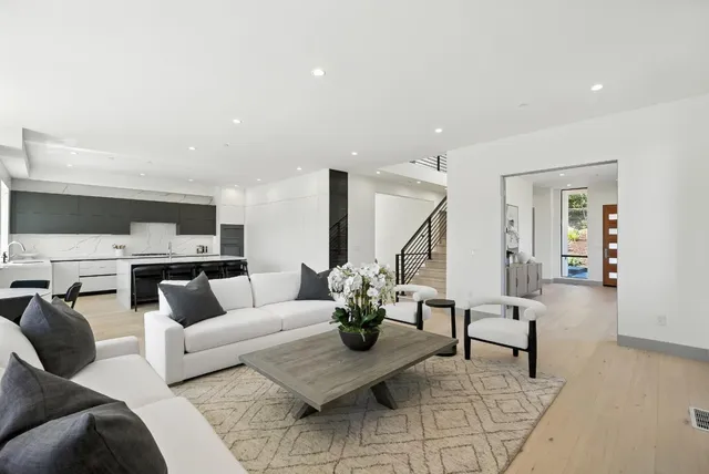a living room with furniture and floor to ceiling windows