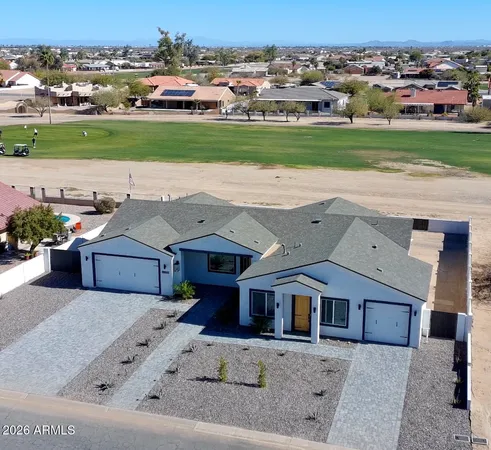 an aerial view of a house with a garden and trees