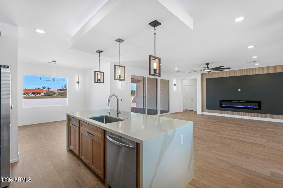 14833 South Brook Hollow Road Arizona City, AZ 85123 - Photo 12 of 61 a kitchen with stainless steel appliances granite countertop a sink a stove and a wooden floor