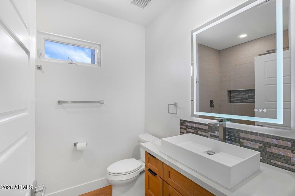 14833 South Brook Hollow Road Arizona City, AZ 85123 - Photo 30 of 61 a bathroom with a sink toilet and mirror