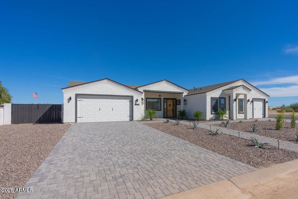 14833 South Brook Hollow Road Arizona City, AZ 85123 - Photo 4 of 61 a front view of a house with a yard and garage