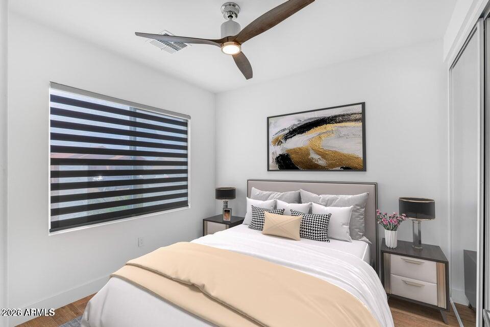 14833 South Brook Hollow Road Arizona City, AZ 85123 - Photo 43 of 61 a bedroom with a bed and a painting on the wall