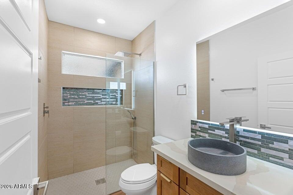 14833 South Brook Hollow Road Arizona City, AZ 85123 - Photo 45 of 61 a bathroom with a sink a toilet a mirror and shower