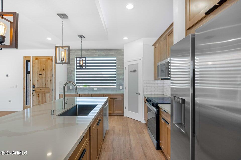 14833 South Brook Hollow Road Arizona City, AZ 85123 - Photo 10 of 61 a kitchen with stainless steel appliances granite countertop a sink a stove and a refrigerator