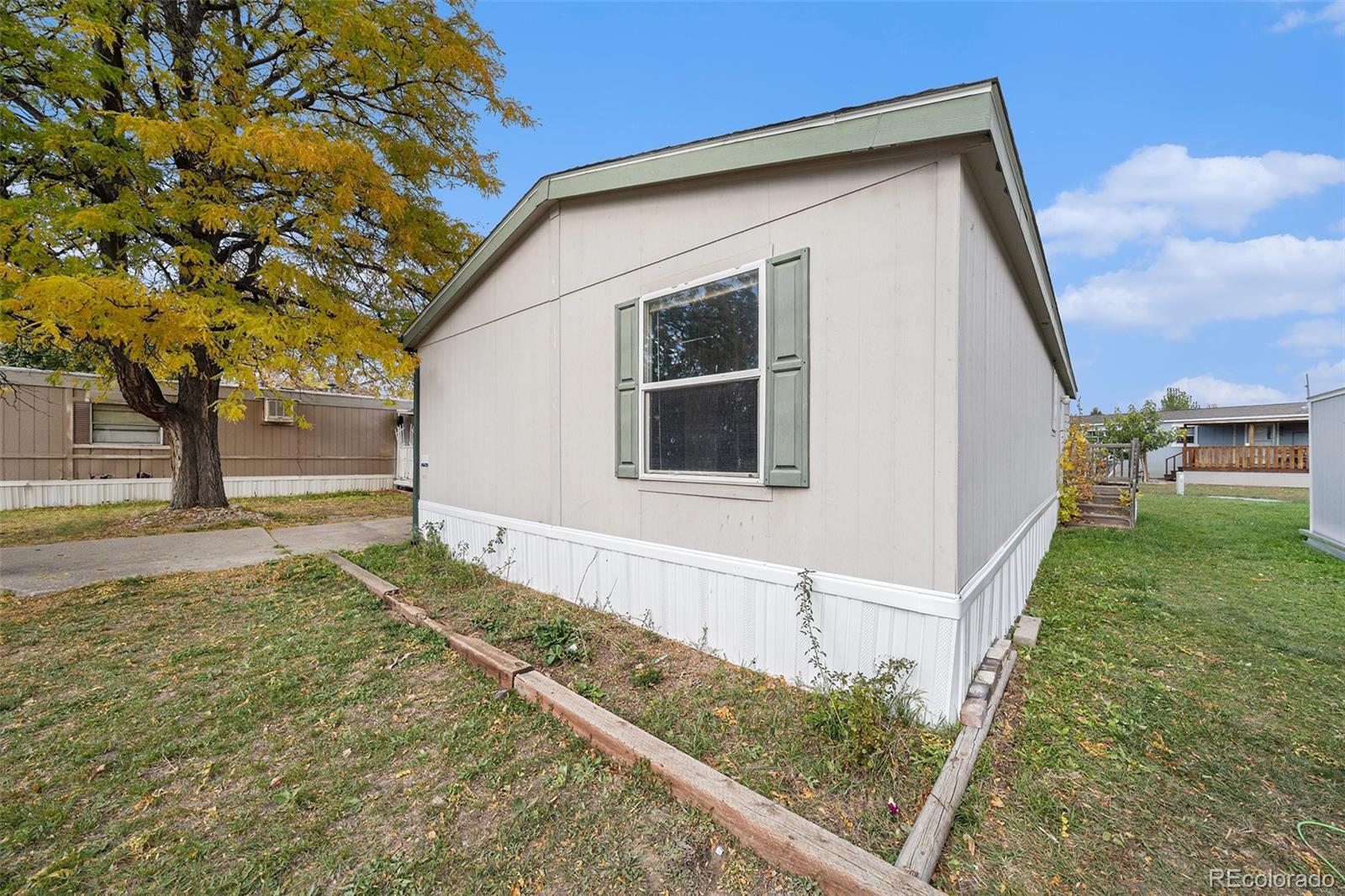 2500 East Harmony Road Fort Collins, CO 80528 - Photo 21 of 23 a front view of a house with a yard