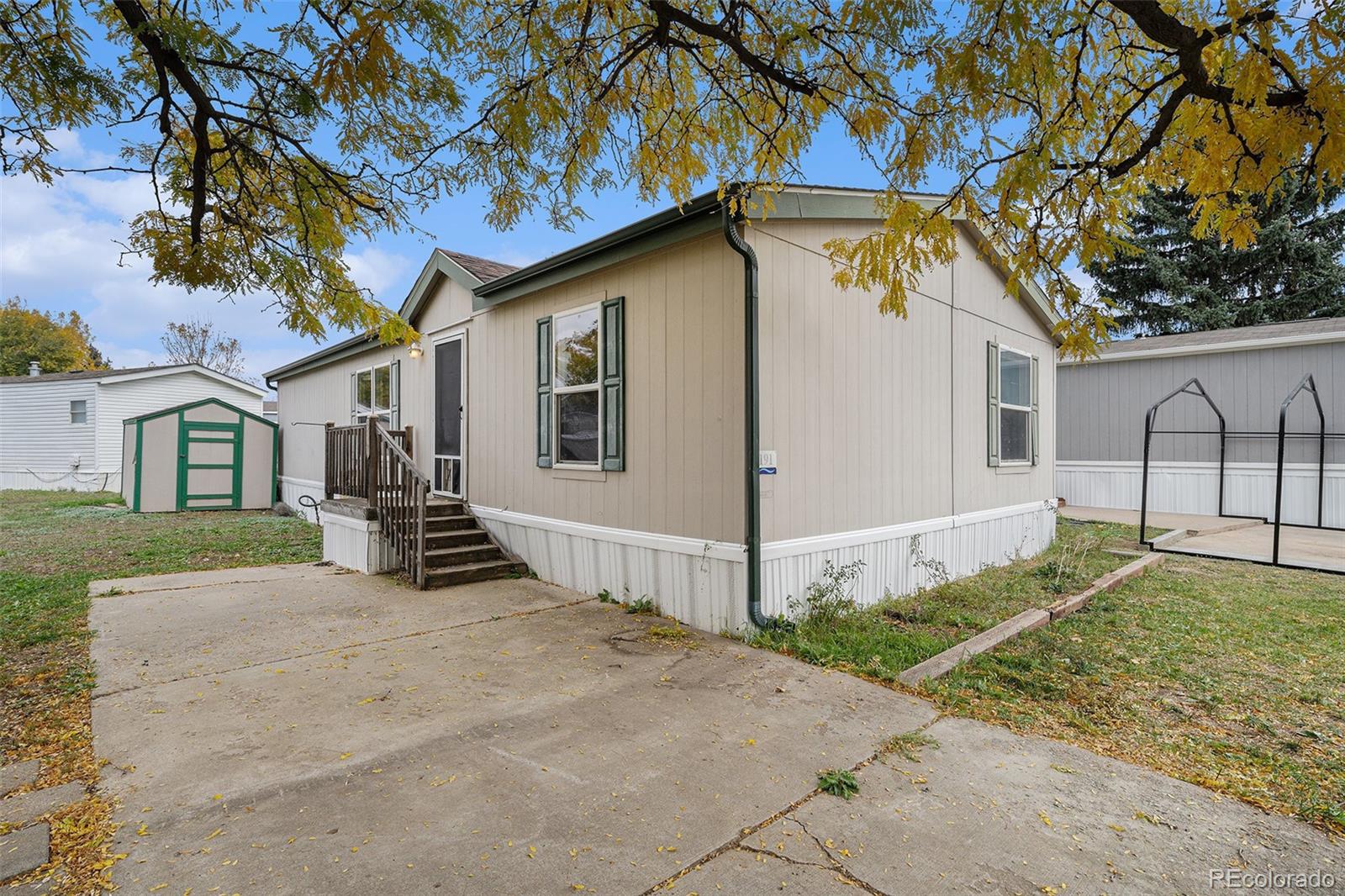 2500 East Harmony Road Fort Collins, CO 80528 - Photo 3 of 23 a view of a house with a yard and garage