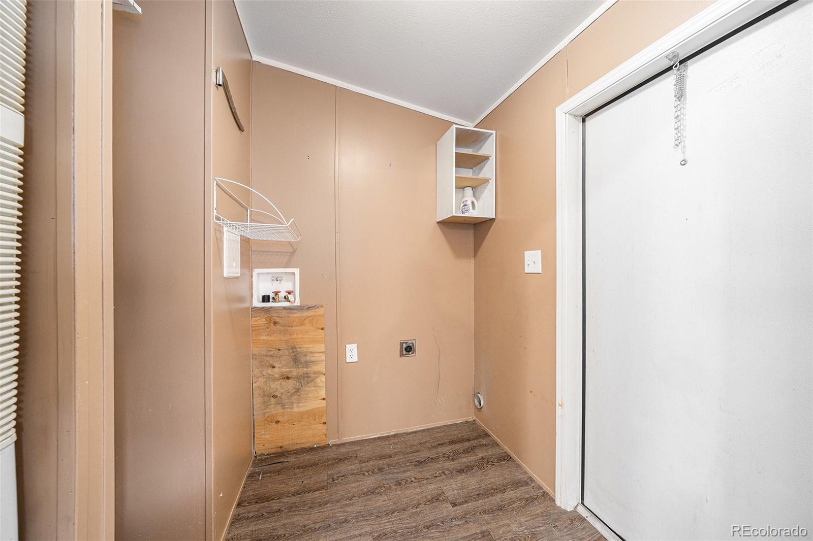 2500 East Harmony Road Fort Collins, CO 80528 - Photo 8 of 23 a view of a hallway with wooden floor and a bathroom