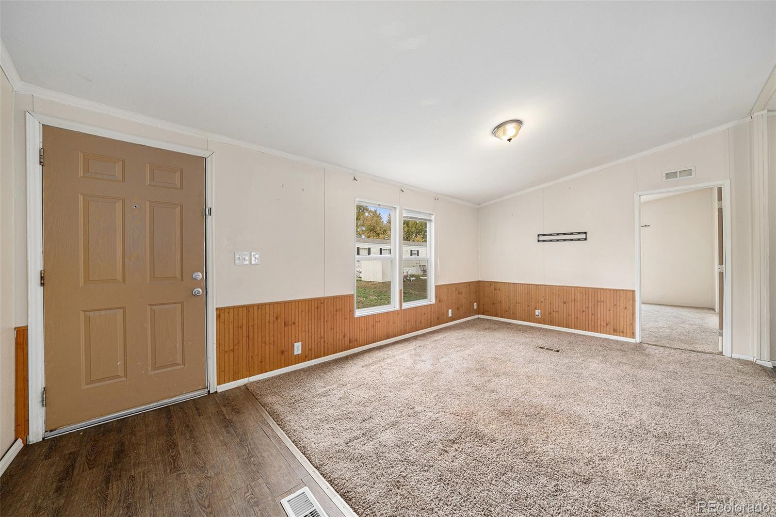 2500 East Harmony Road Fort Collins, CO 80528 - Photo 9 of 23 an empty room with wooden floor and windows