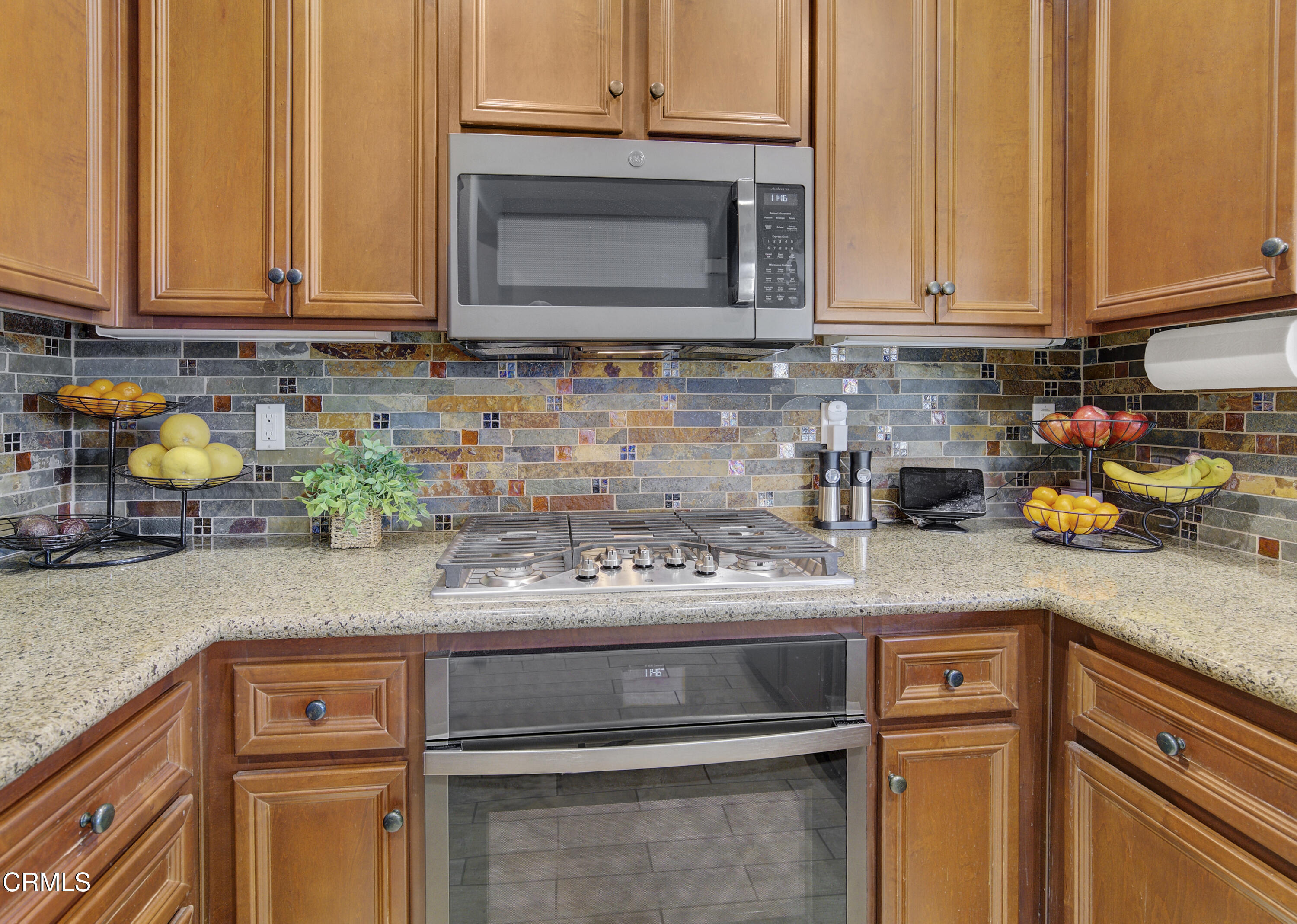 3233 Moss Landing Boulevard Oxnard, CA 93036 - Photo 11 of 57 a kitchen with stainless steel appliances granite countertop a sink stove and microwave
