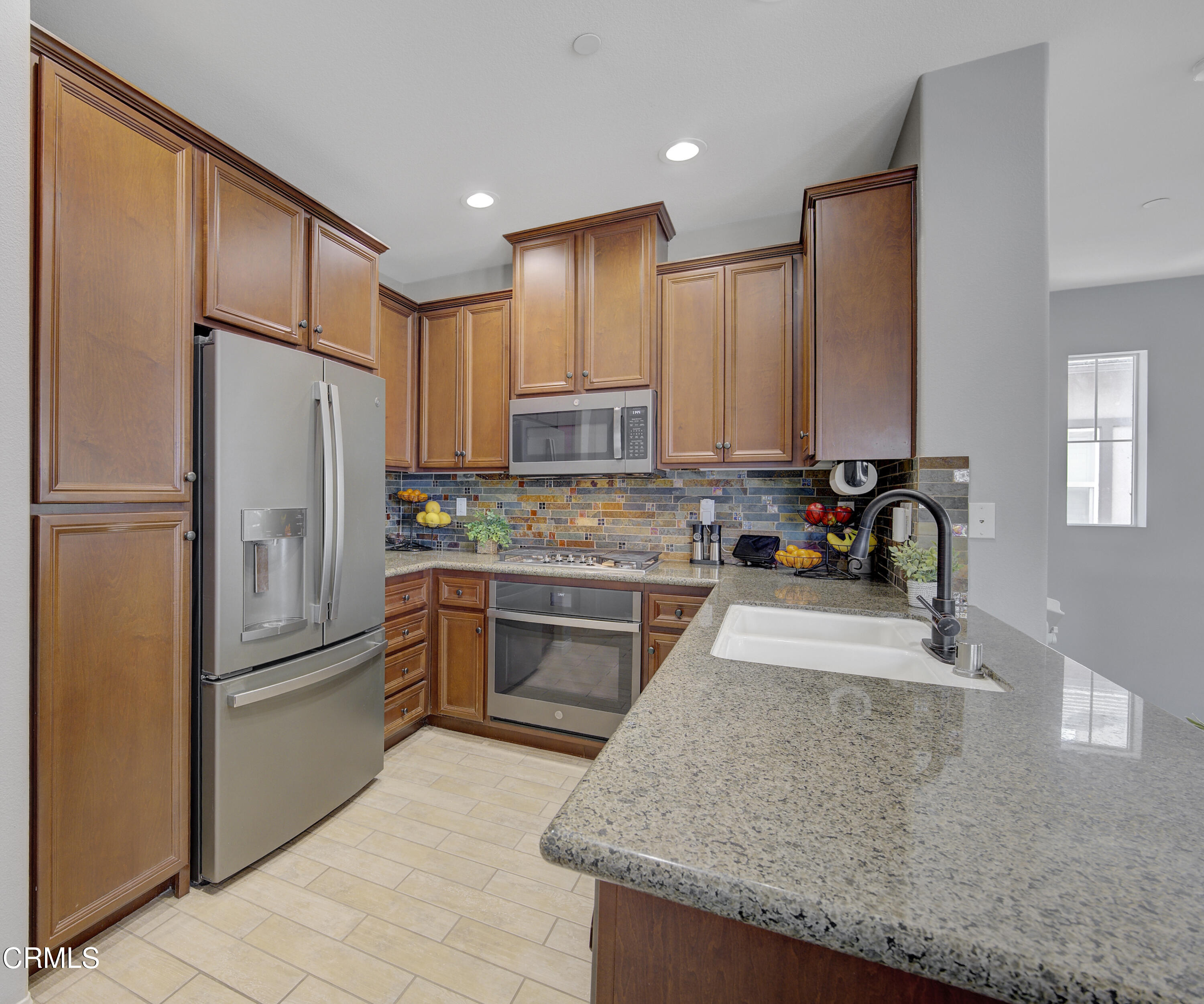 3233 Moss Landing Boulevard Oxnard, CA 93036 - Photo 12 of 57 a kitchen with stainless steel appliances granite countertop a refrigerator stove and sink