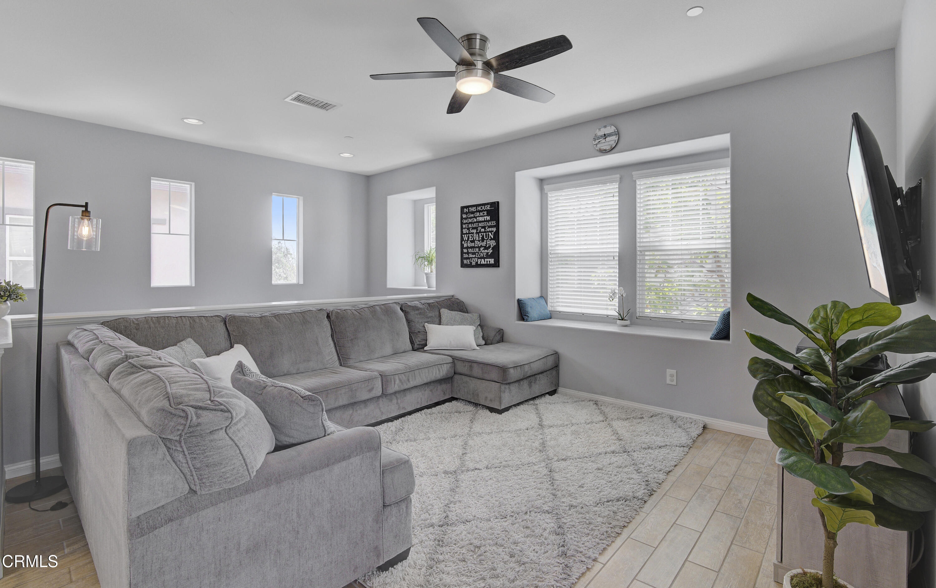 3233 Moss Landing Boulevard Oxnard, CA 93036 - Photo 8 of 57 a living room with furniture a large window and a potted plant