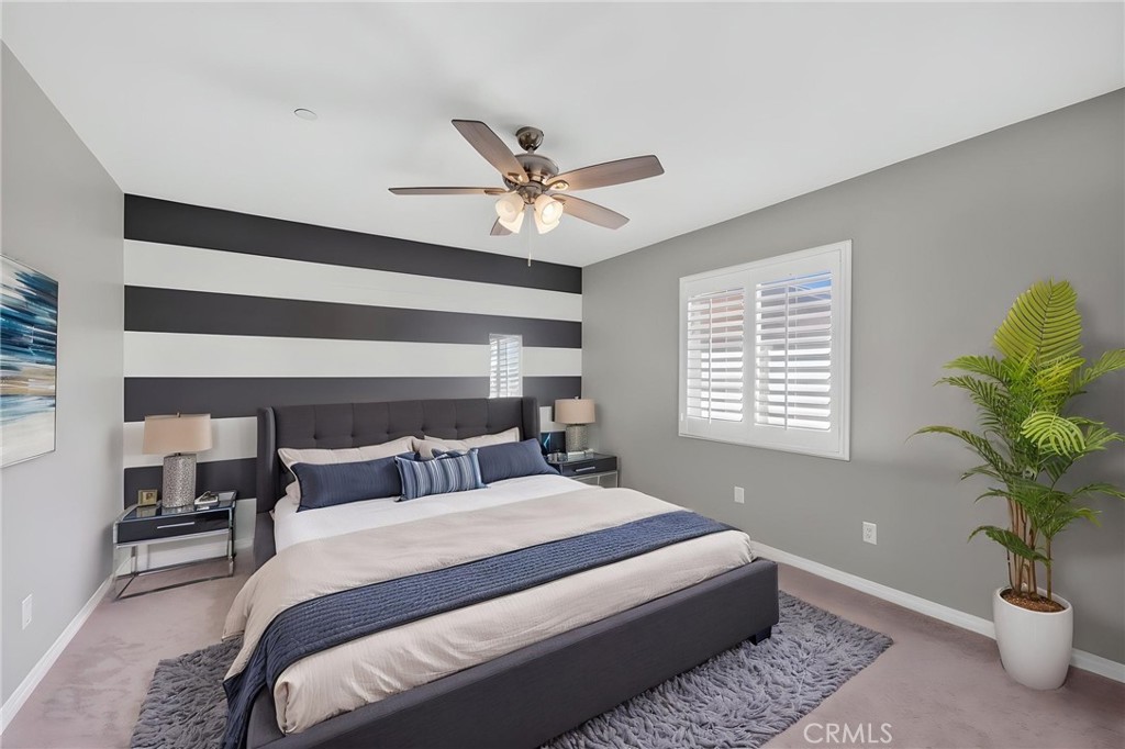 23347 Crystal Way Wildomar, CA 92595 - Photo 70 of 109 a bedroom with a large bed and a potted plant