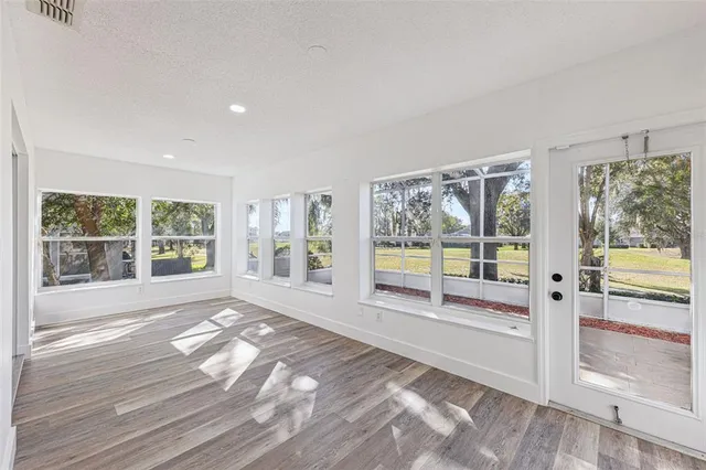 an aerial view of residential houses with outdoor space and trees