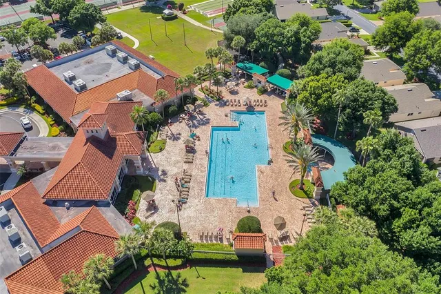 a swimming pool view with a seating space and a garden