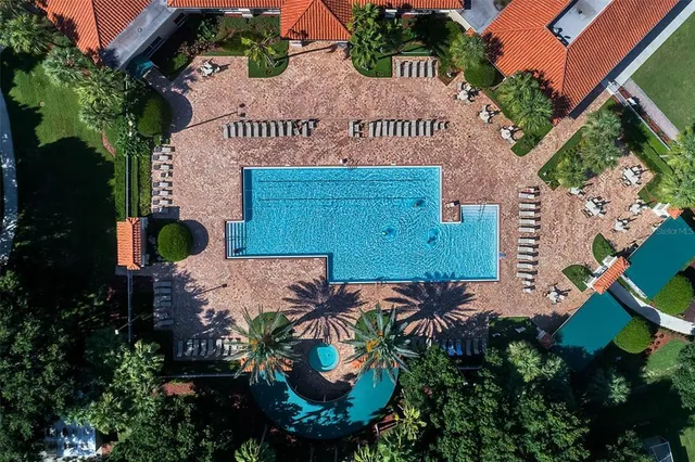 a view of a house with a swimming pool and a yard