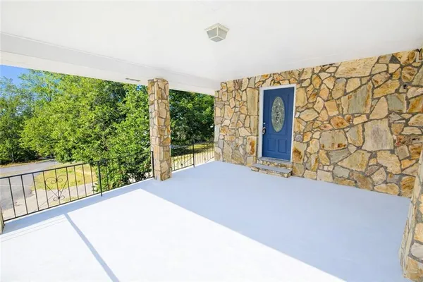 a balcony with trees in front of it