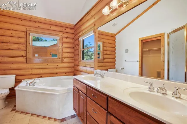 a bathroom with a sink a bathtub and a window