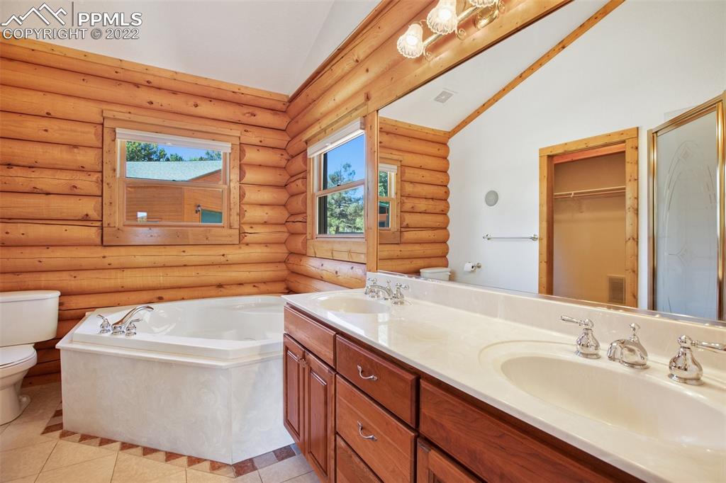 883 Rocky Mountain View Divide, CO 80814 - Photo 12 of 35 a bathroom with a sink a bathtub and a window