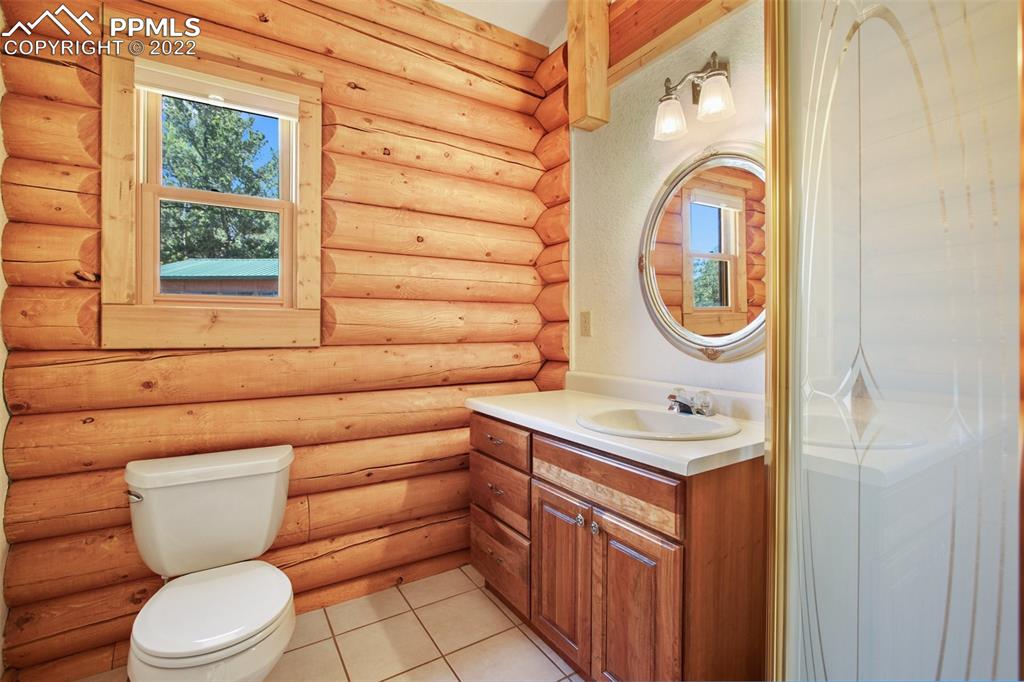 883 Rocky Mountain View Divide, CO 80814 - Photo 15 of 35 a bathroom with a sink a toilet and a mirror