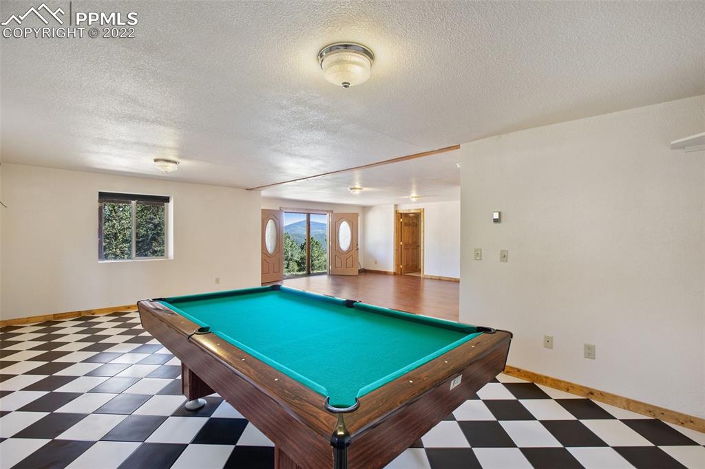 883 Rocky Mountain View Divide, CO 80814 - Photo 20 of 35 a room with pool table and windows