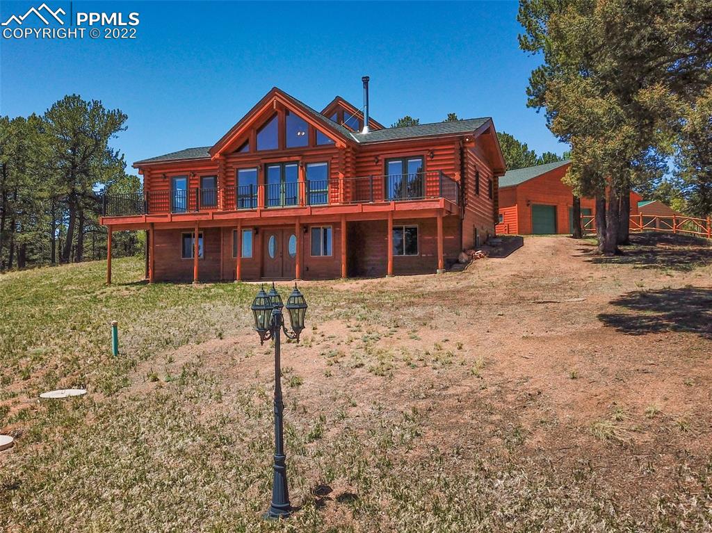 883 Rocky Mountain View Divide, CO 80814 - Photo 30 of 35 a front view of a house with a yard