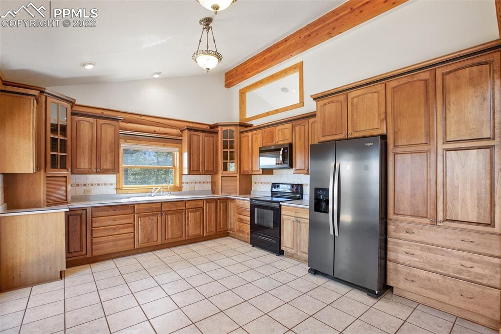 883 Rocky Mountain View Divide, CO 80814 - Photo 9 of 35 a kitchen with stainless steel appliances granite countertop a refrigerator and a sink