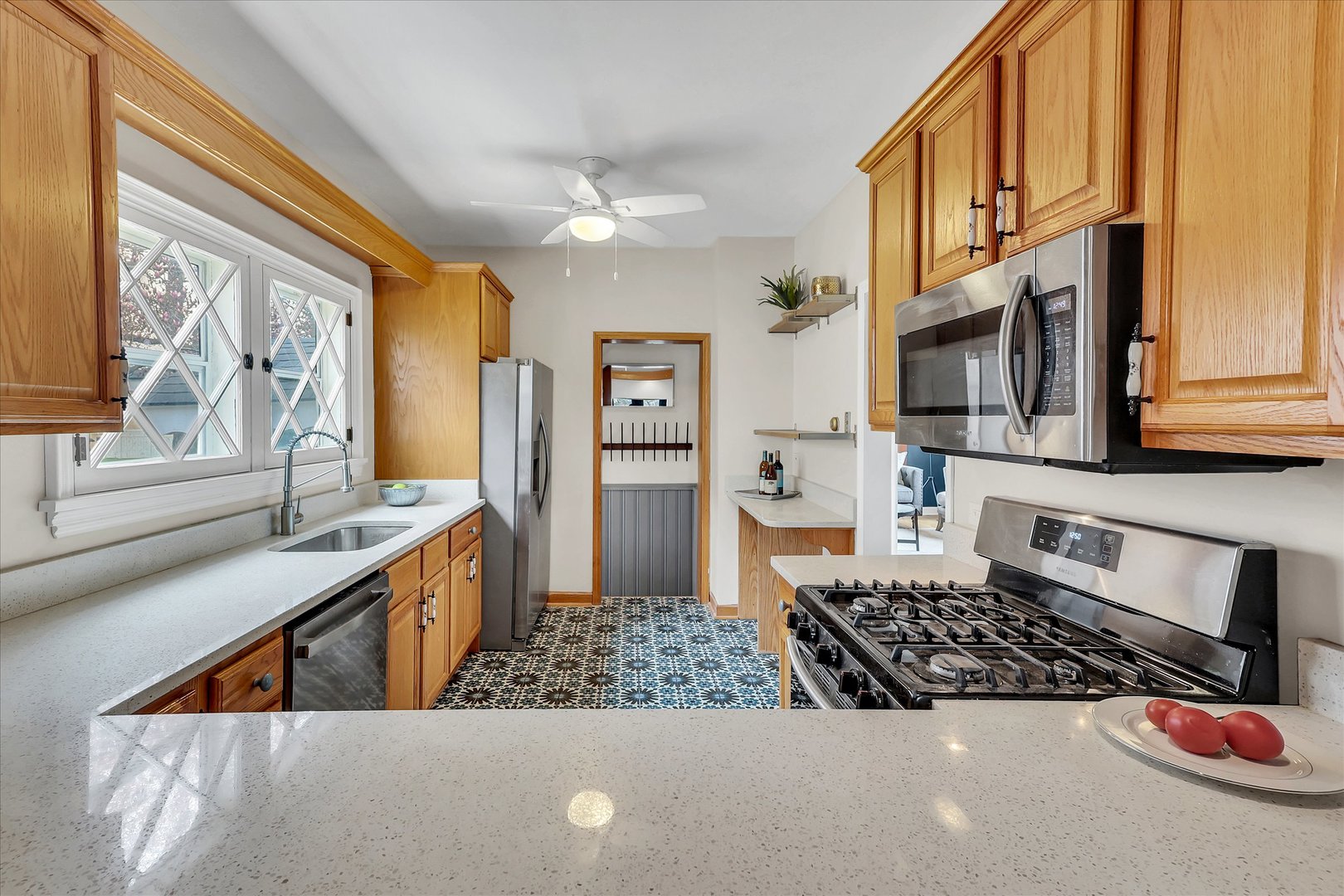 4038 Grove Avenue Brookfield, IL 60513 - Photo 19 of 45 a kitchen with stainless steel appliances kitchen island granite countertop a sink and cabinets