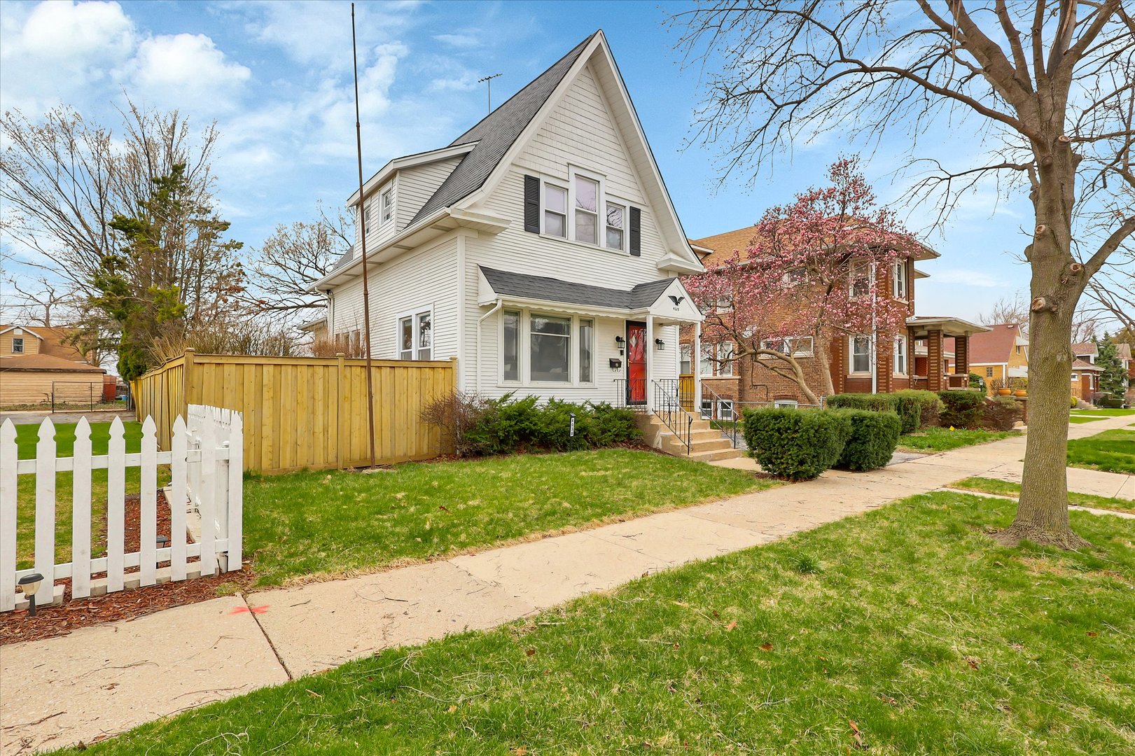 4038 Grove Avenue Brookfield, IL 60513 - Photo 2 of 45 a front view of a house with a yard and garage