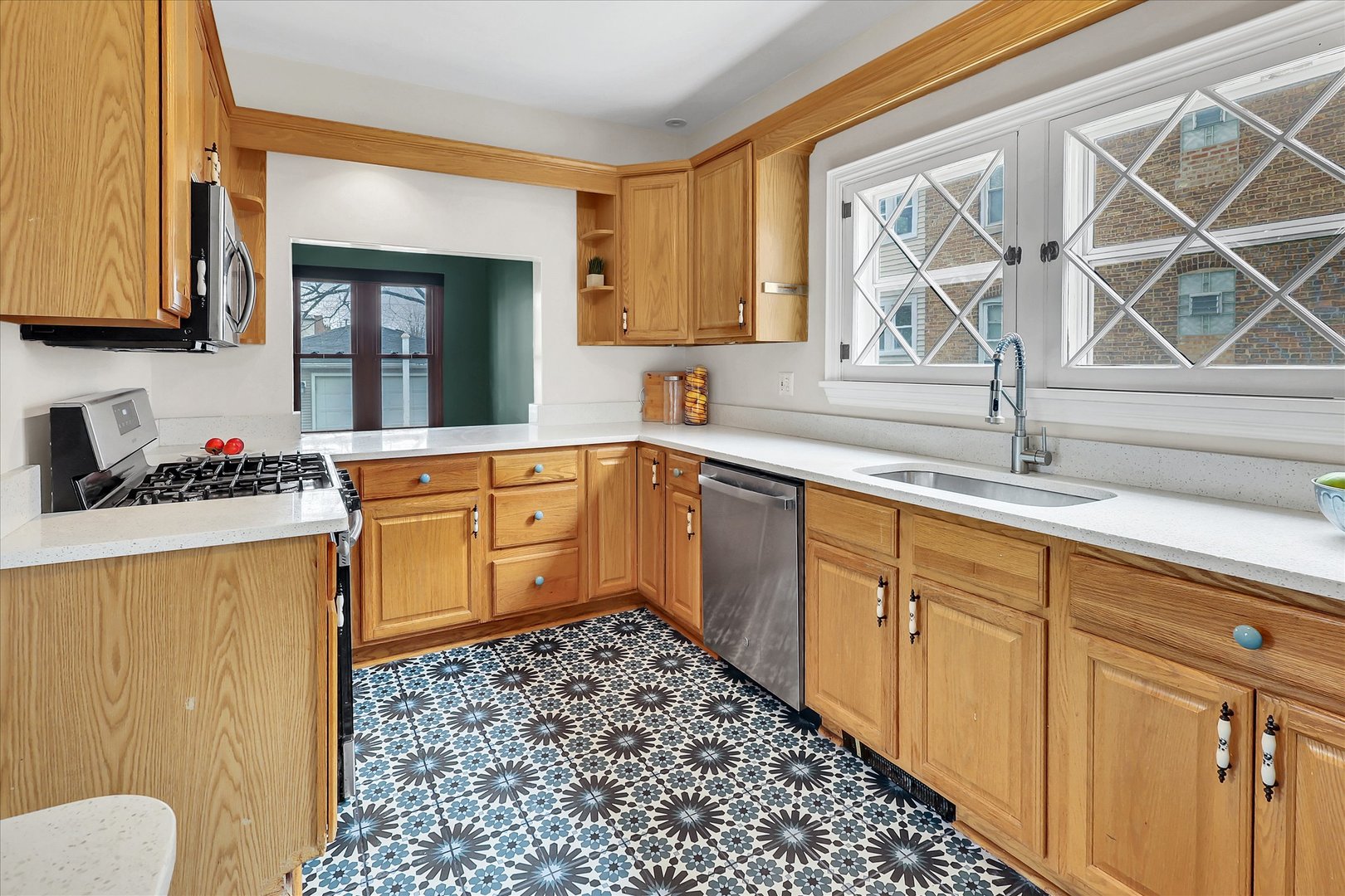 4038 Grove Avenue Brookfield, IL 60513 - Photo 21 of 45 a kitchen with stainless steel appliances a sink cabinets and a window