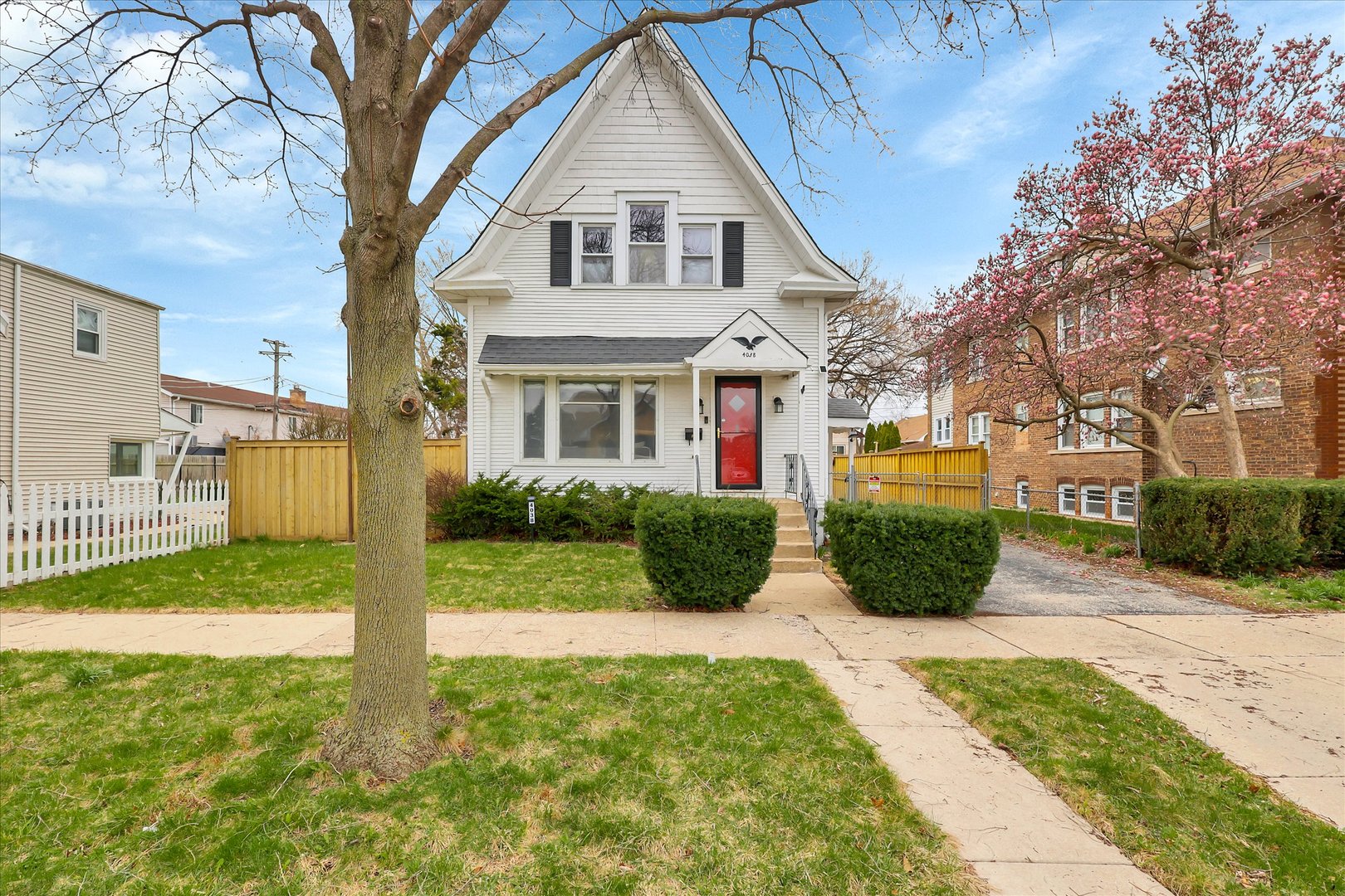 4038 Grove Avenue Brookfield, IL 60513 - Photo 3 of 45 a view of a white house next to a yard with big trees