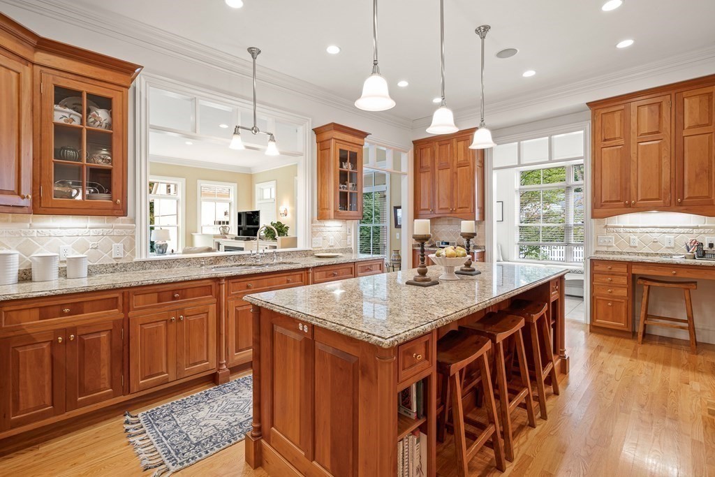 135 Washington Street Wellesley, MA 02481 - Photo 11 of 39 a kitchen with stainless steel appliances granite countertop a stove a sink dishwasher and a wooden cabinets with large window