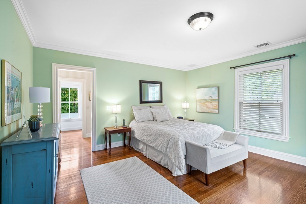 135 Washington Street Wellesley, MA 02481 - Photo 17 of 39 a bedroom with a large bed wooden floor and windows