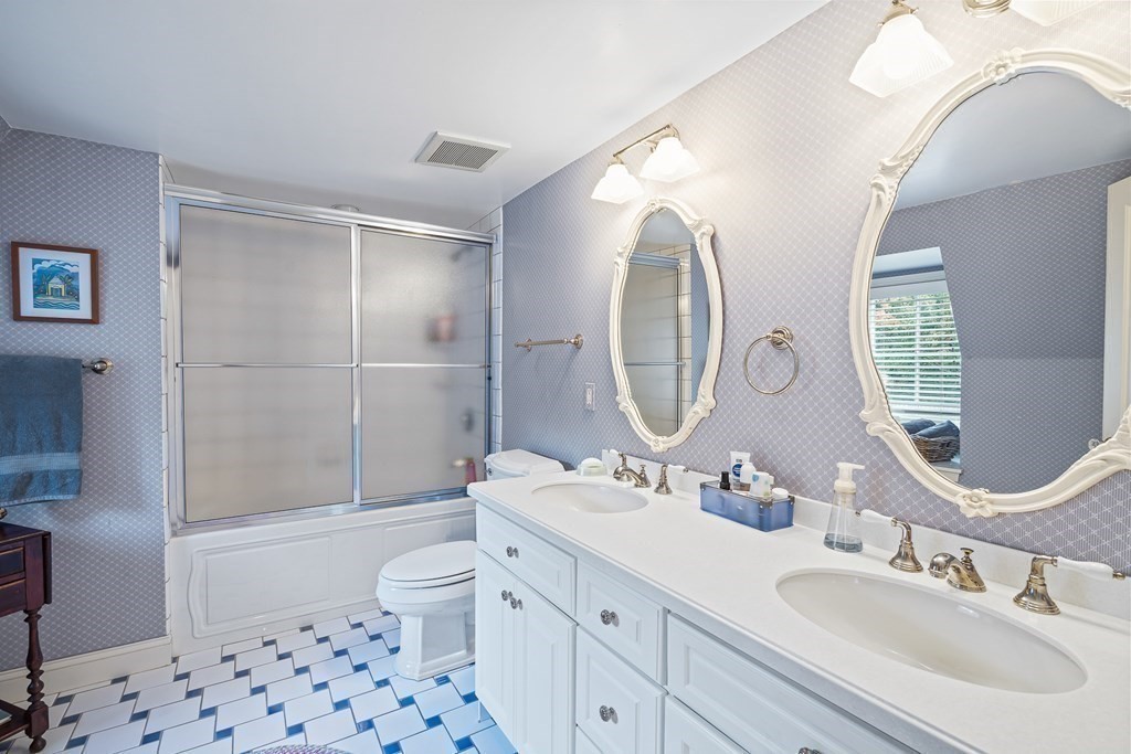 135 Washington Street Wellesley, MA 02481 - Photo 27 of 39 a bathroom with a double vanity sink toilet mirror and shower