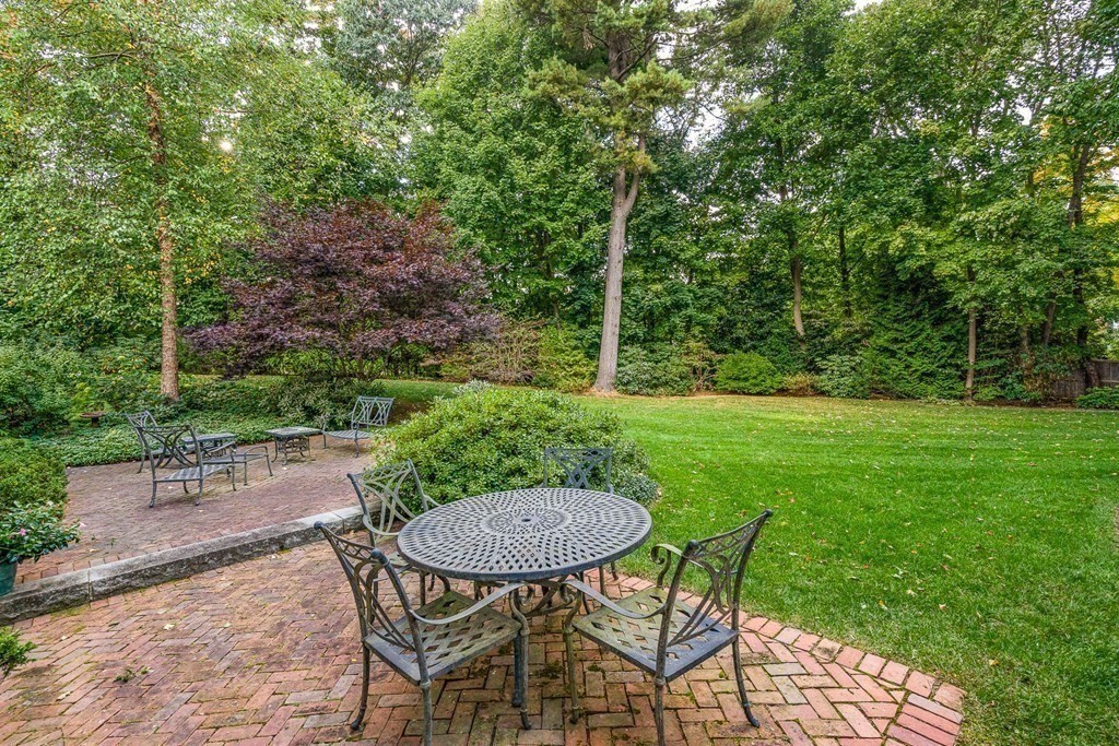 135 Washington Street Wellesley, MA 02481 - Photo 32 of 39 a view of a backyard with table and chairs with a table and chair