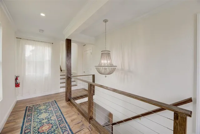 a view of an empty room and wooden floor