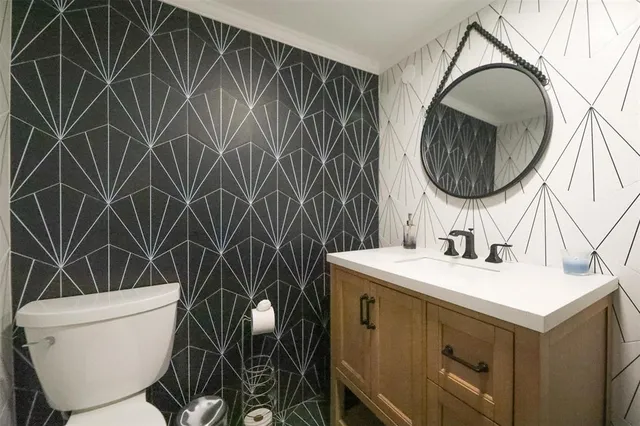 a bathroom with a sink toilet and mirror