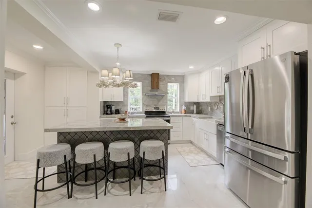 a kitchen with refrigerator a sink and cabinets