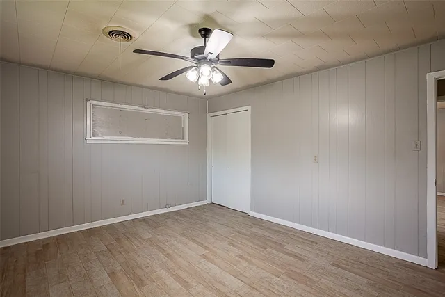 a view of a room with wooden floor and windows