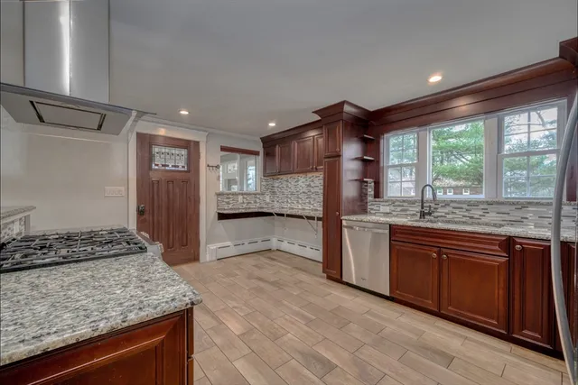 a kitchen with stainless steel appliances granite countertop a sink stove and refrigerator