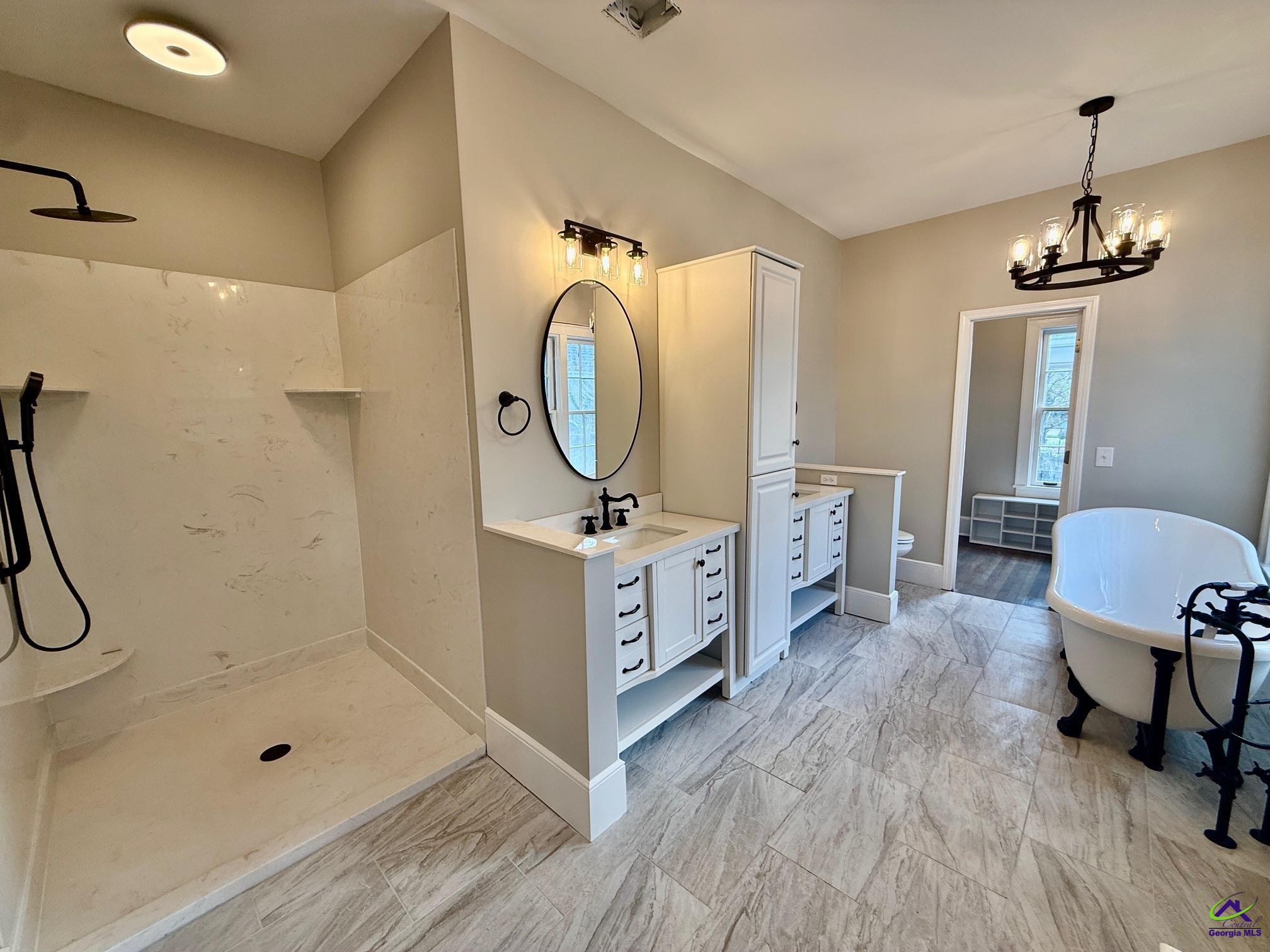515 Engram Street Montezuma, GA 31063 - Photo 17 of 35 a spacious bathroom with a double vanity sink a mirror and a shower