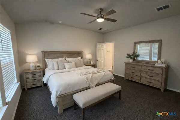 a bedroom with a bed and a dresser