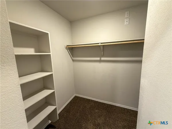 a view of an empty walk in closet